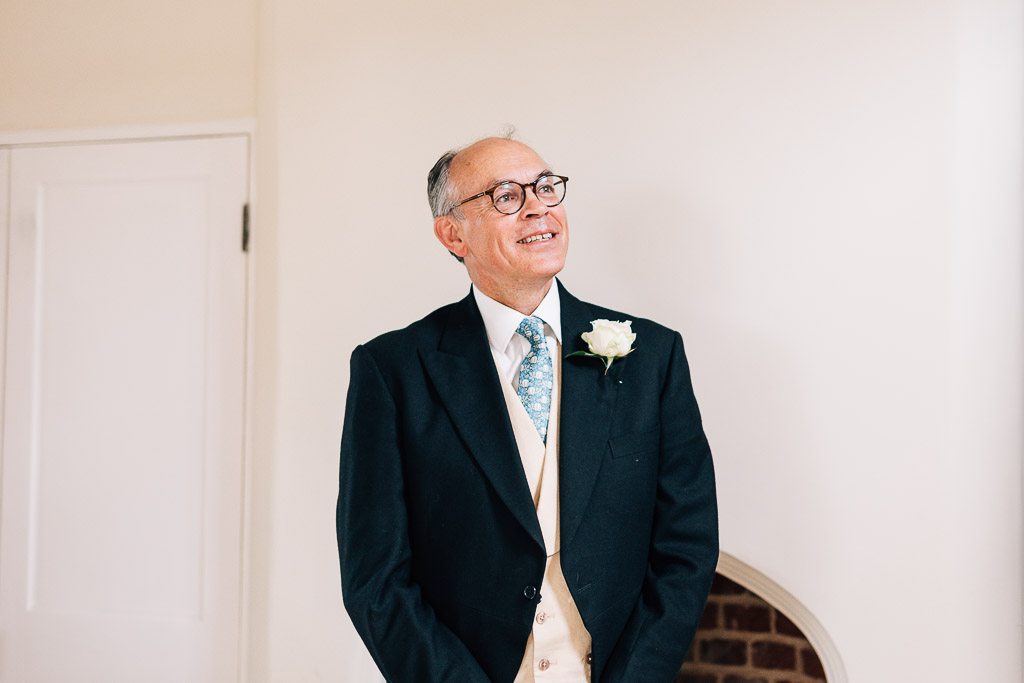 bride's dad watching bride walk downstairs
