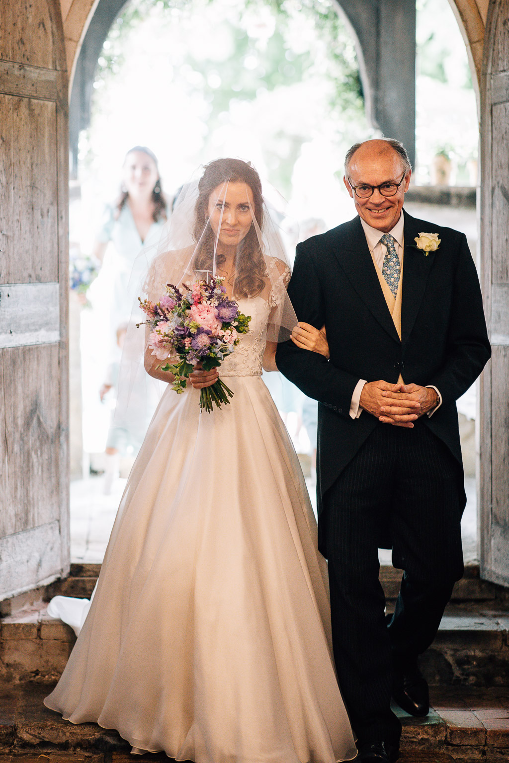 bride and dad walking into church