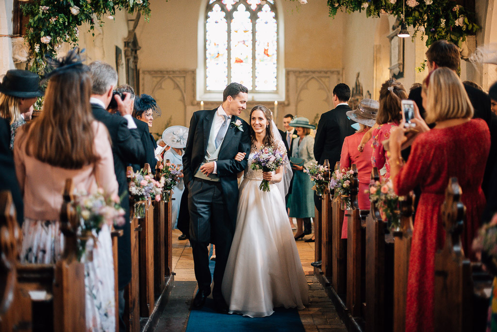 bride and groom walking down aisle