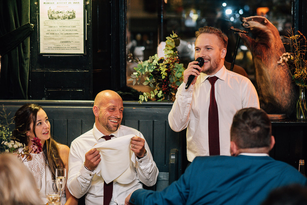 best man giving wedding speech in quirky pub