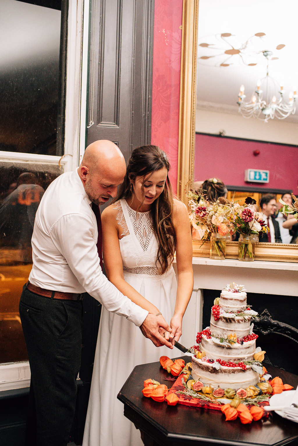 bride and groom cutting cake at rosemary branch pub reception